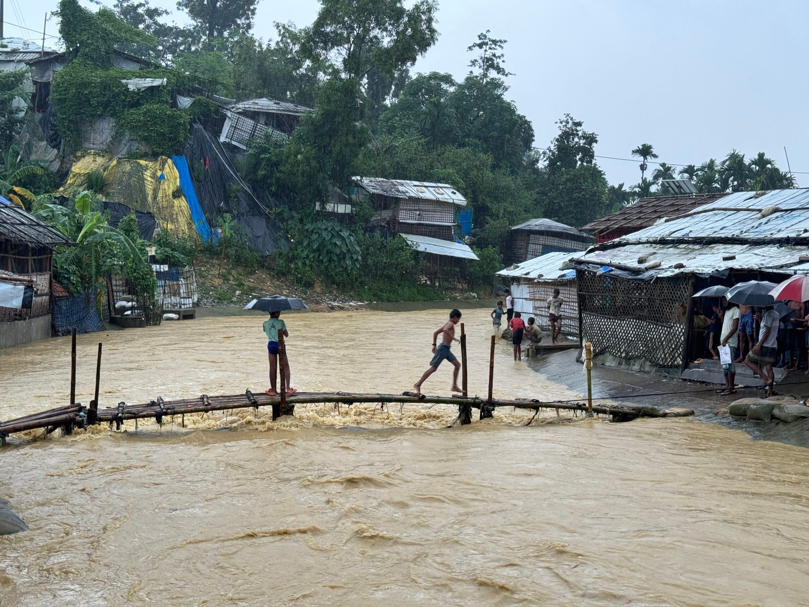 These are the Rohingya children that enjoy the rainfall in camp. These children cross the bamboo bridge that attaches between two camps. photo courtesy of Ro Yassin Abdumonab
